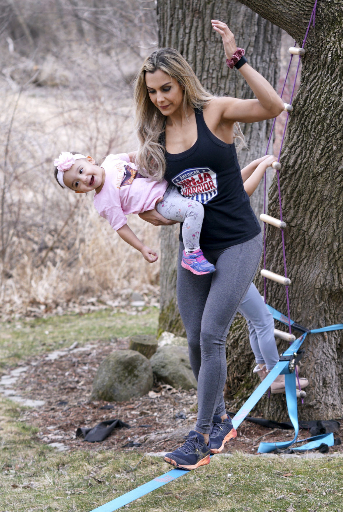 Yarizett Breunig holding daughter Gizelle during workout